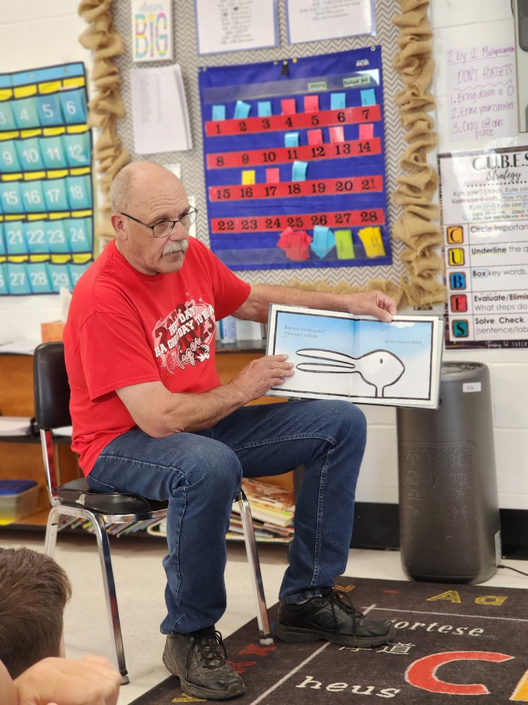 Guests read to students. 