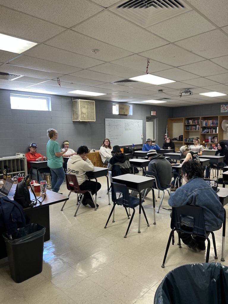 Students hear a presentation from director of the caring center.