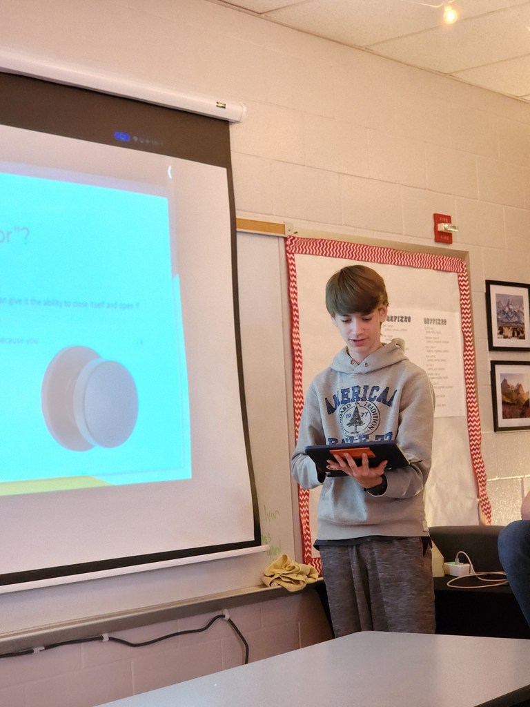Students present their Shark Tank projects.