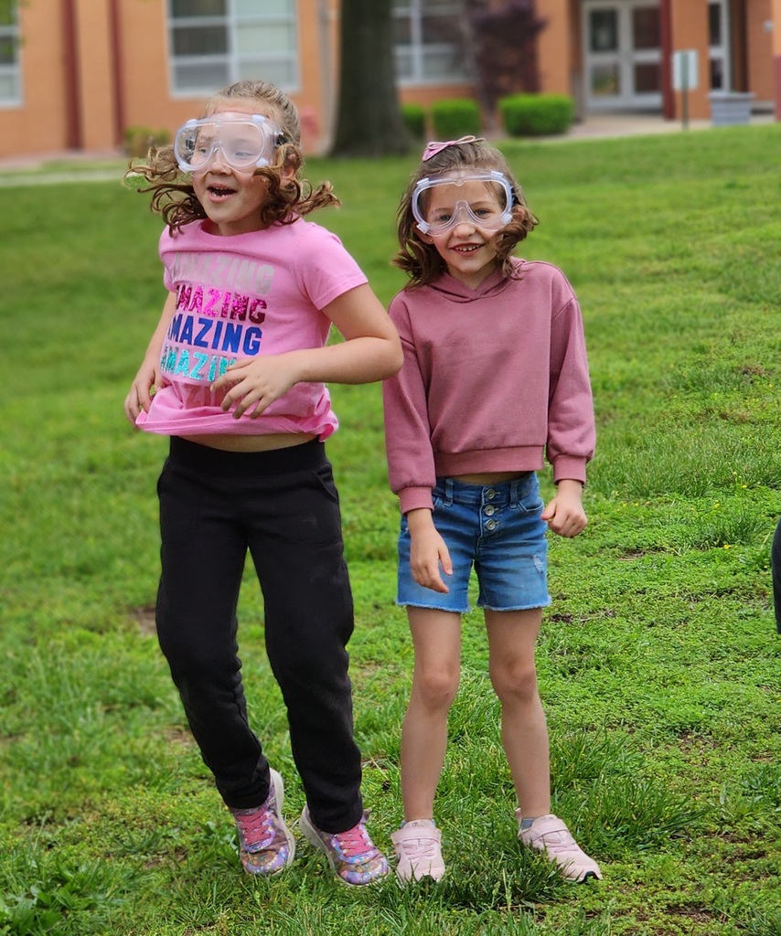 Kindergarten students conduct a science experiment for mentos versus soda. 