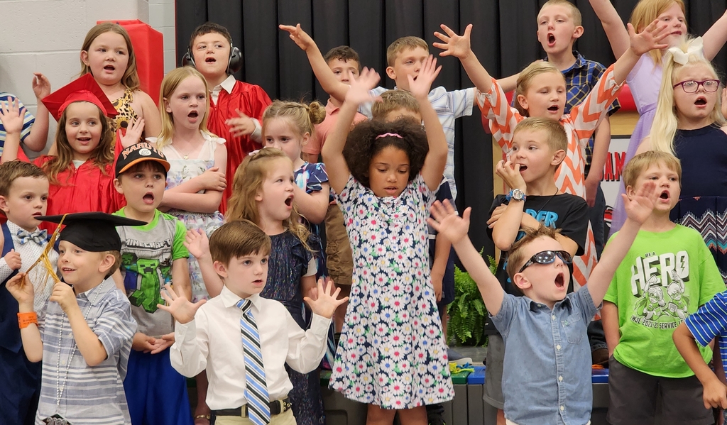 Students perform songs at Kindergarten graduation. 