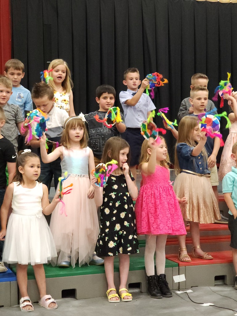 Students perform songs at Kindergarten graduation. 