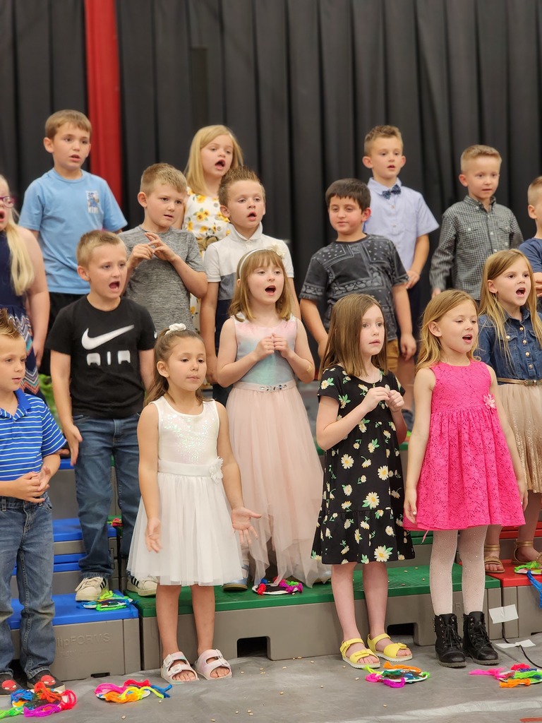 Students perform songs at Kindergarten graduation.