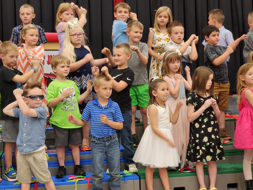 Students perform songs at Kindergarten graduation.